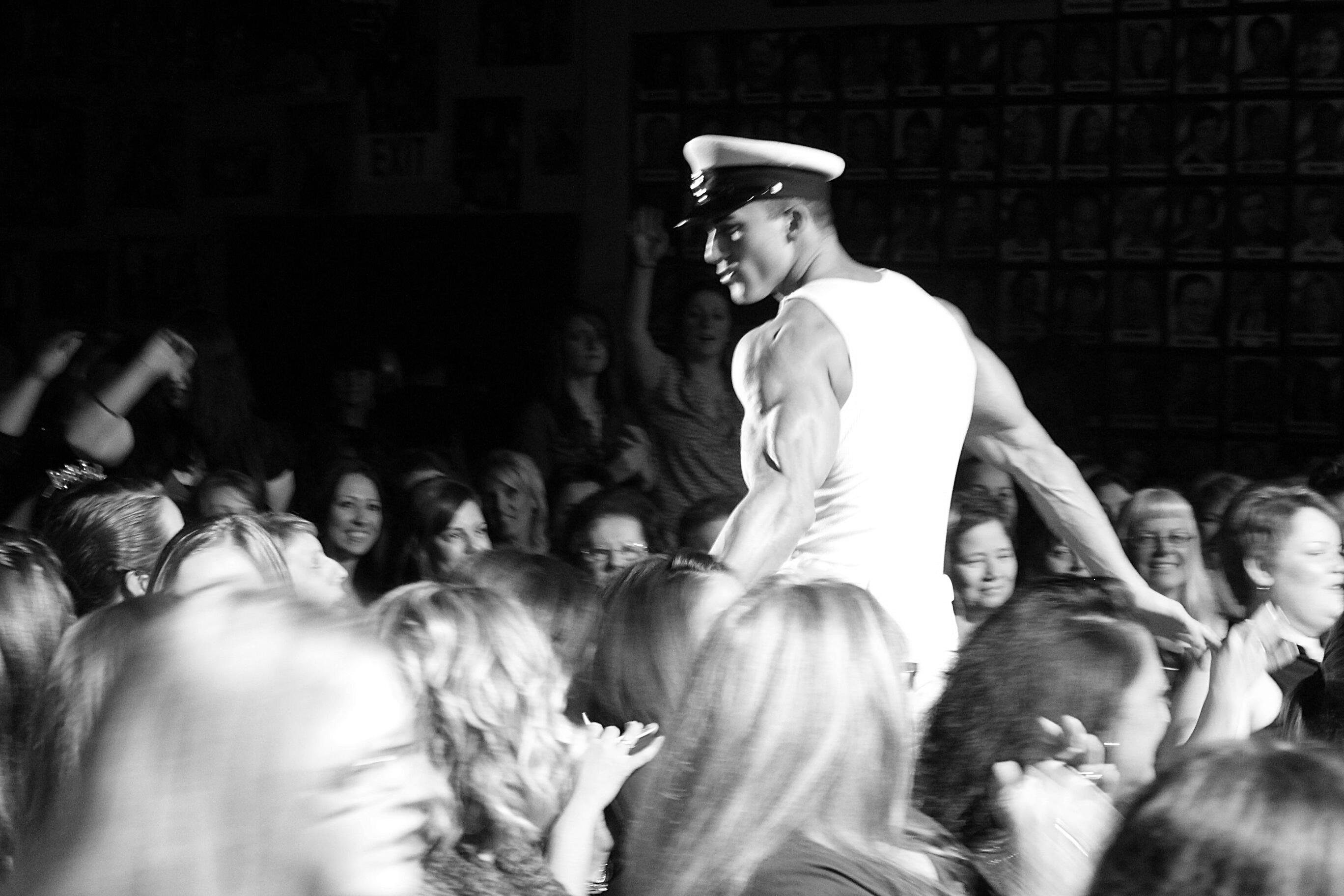 Tom Rooney performing in the audience as a Naval officer Headline Performer and author Thomas (Tom) Rooney performing his Naval officer show in a audience full of screaming fans